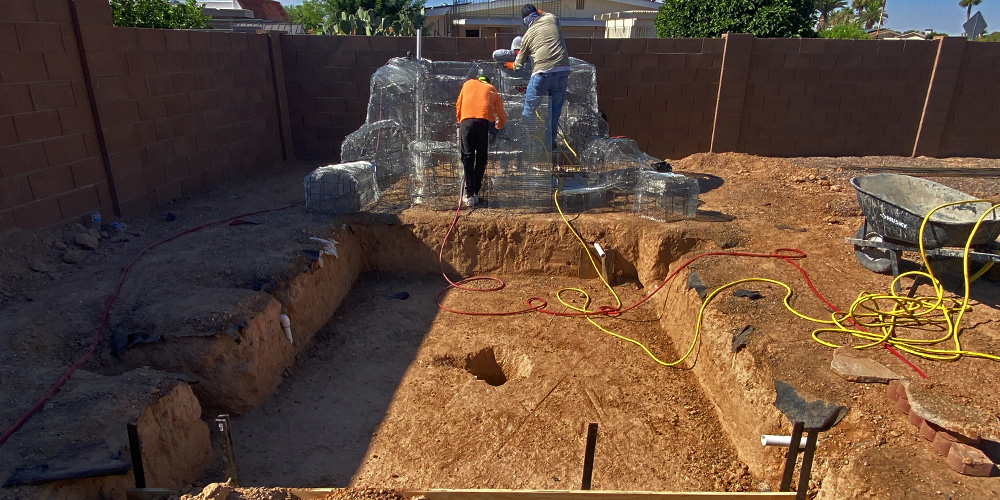 Photo of Workers starting building a pool and some stones